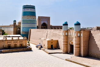 a large building with a tall tower in the background
