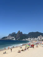 Traveler relaxing on a vibrant beach in Rio de Janeiro with iconic cityscape behind.