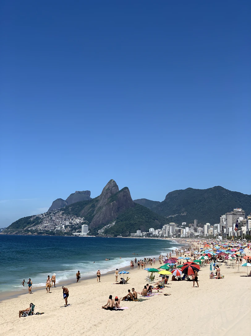 a crowded beach with many people on it