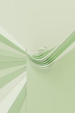 a green and white wall with a stack of folded papers