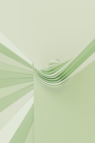 a green and white wall with a stack of folded papers