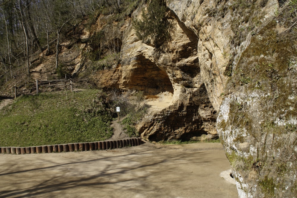 a person riding a bike on a road near a cliff