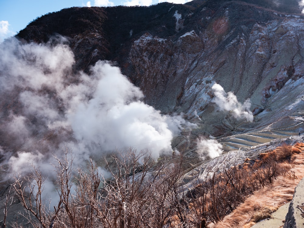 a view of a mountain with steam coming out of it