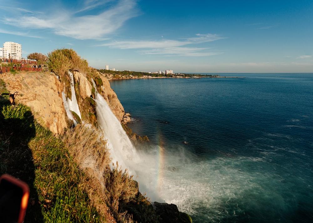 a waterfall with a rainbow in the middle of the water