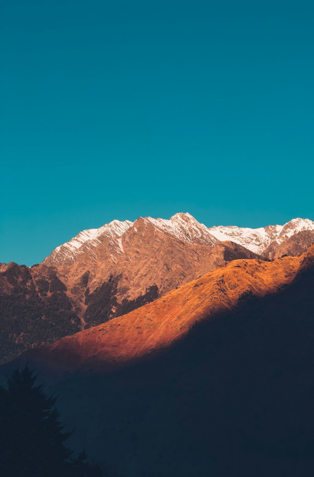 a view of a mountain range with snow on the top