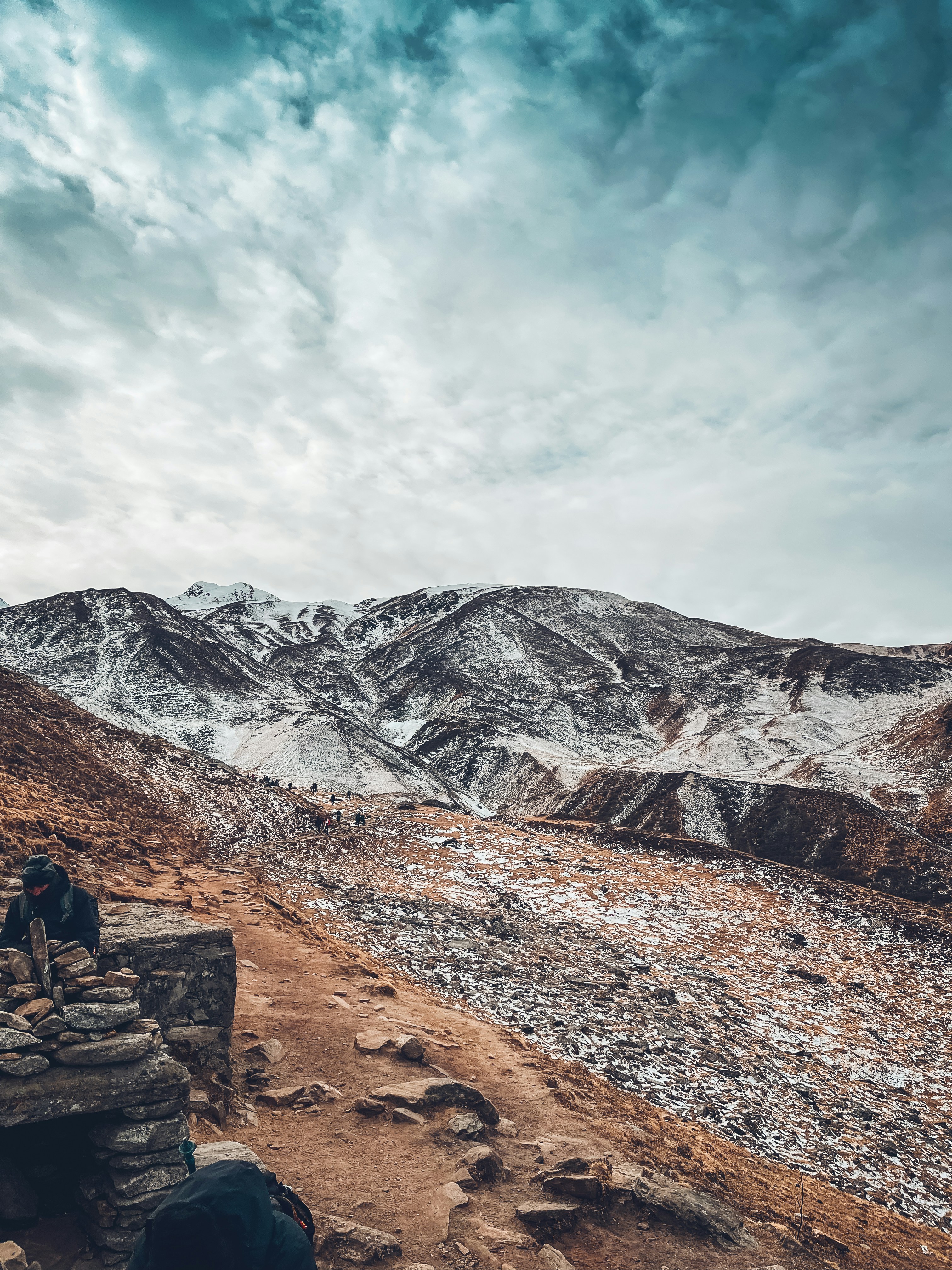 a couple of people sitting on top of a wooden bench