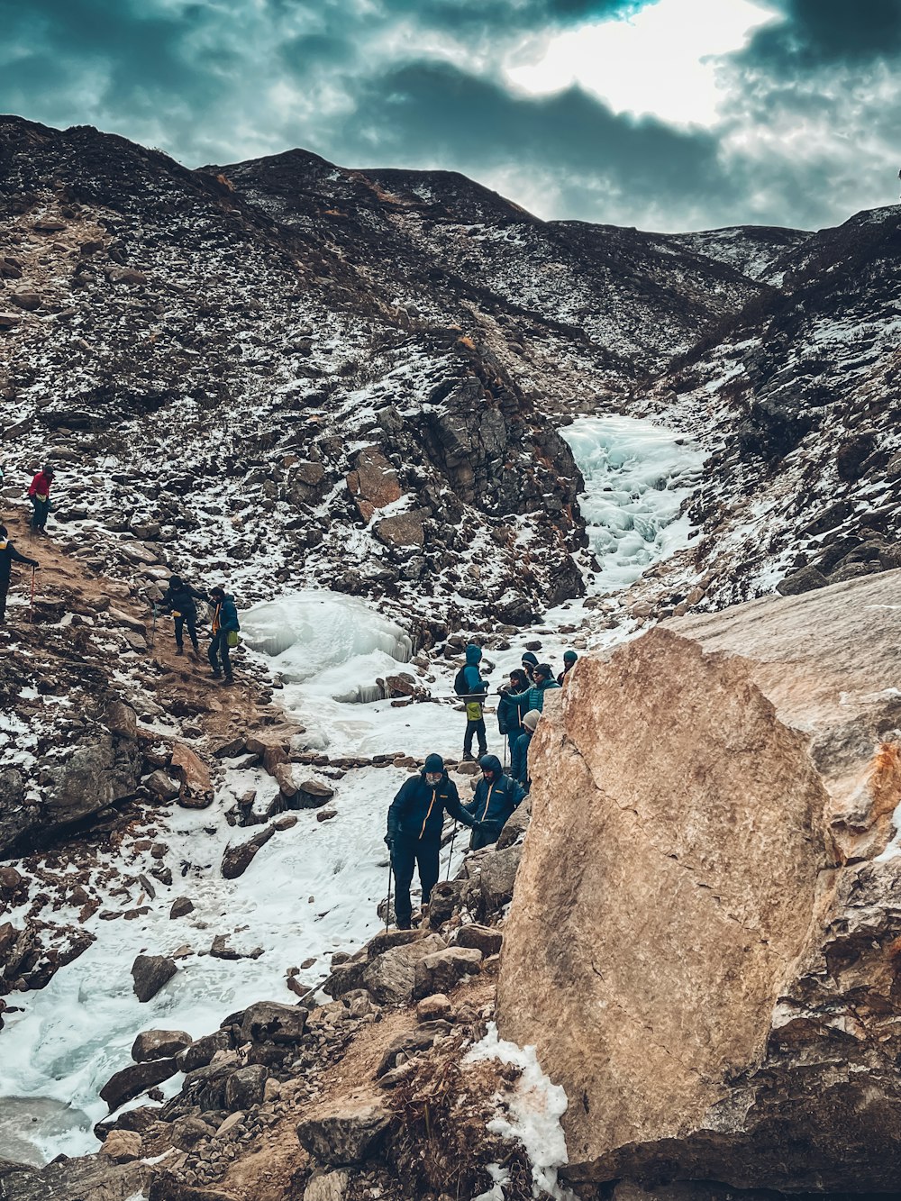 a group of people climbing up a snowy mountain