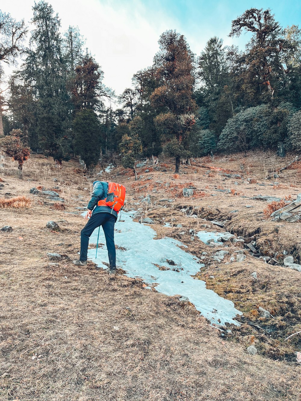 a man with a backpack is standing on a path