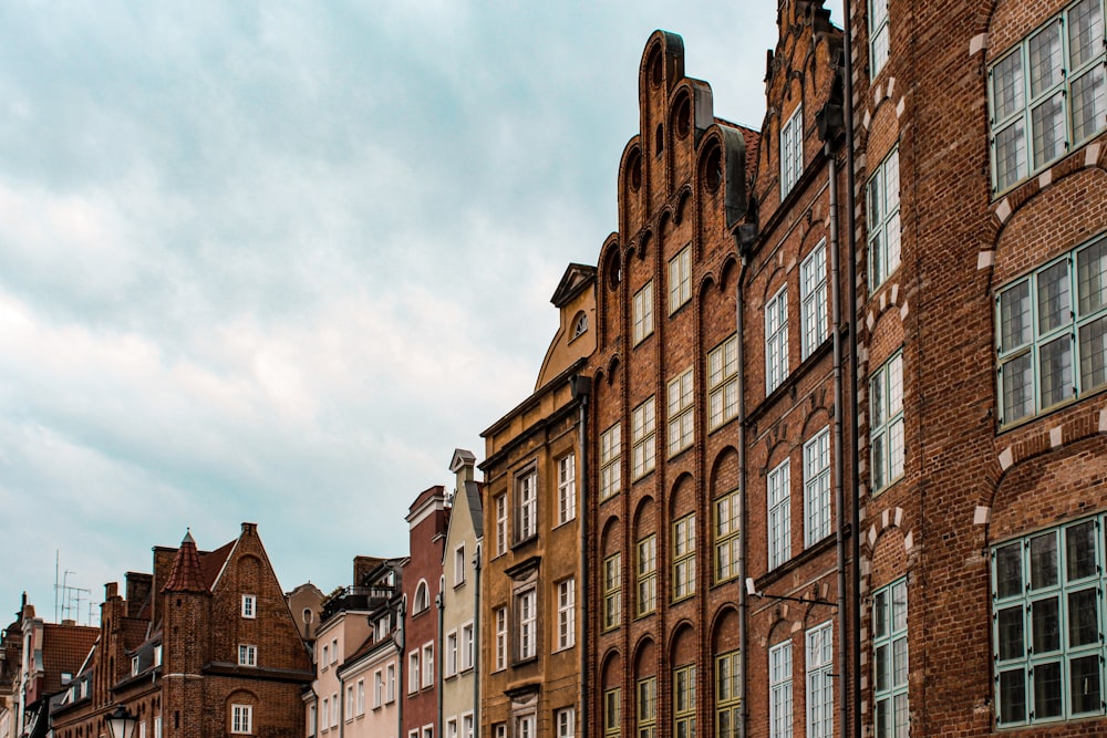 a row of brick buildings on a cloudy day