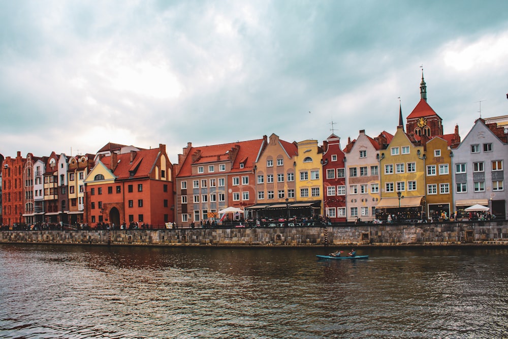 a row of buildings next to a body of water