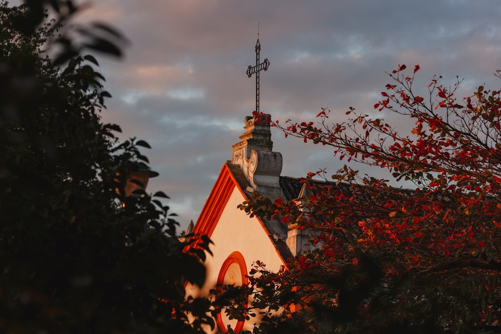 a church steeple with a weather vane on top of it