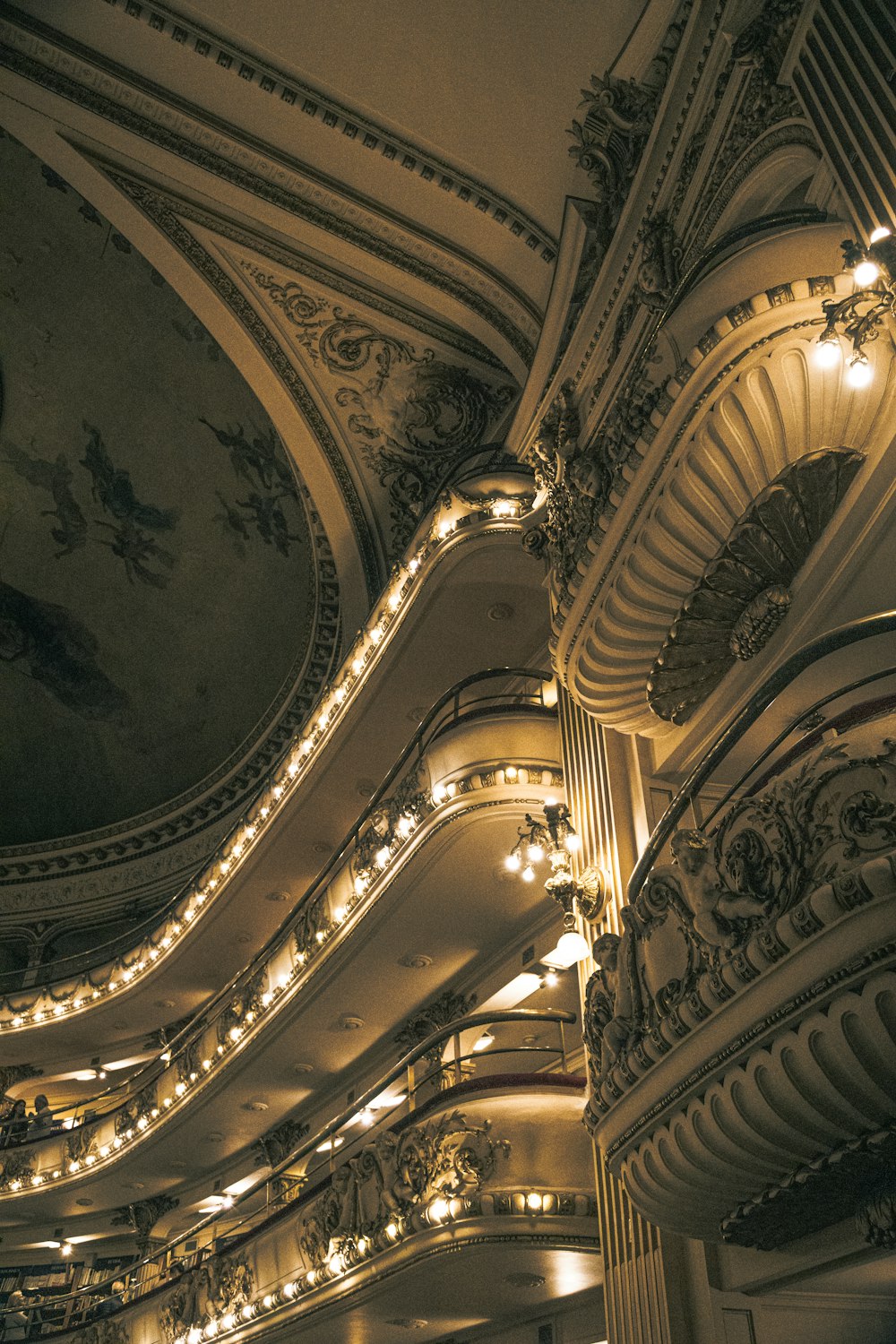 the ceiling of a large building with many lights