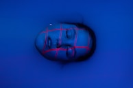 Close-up of a freediver's face, eyes closed in peaceful concentration before a dive.