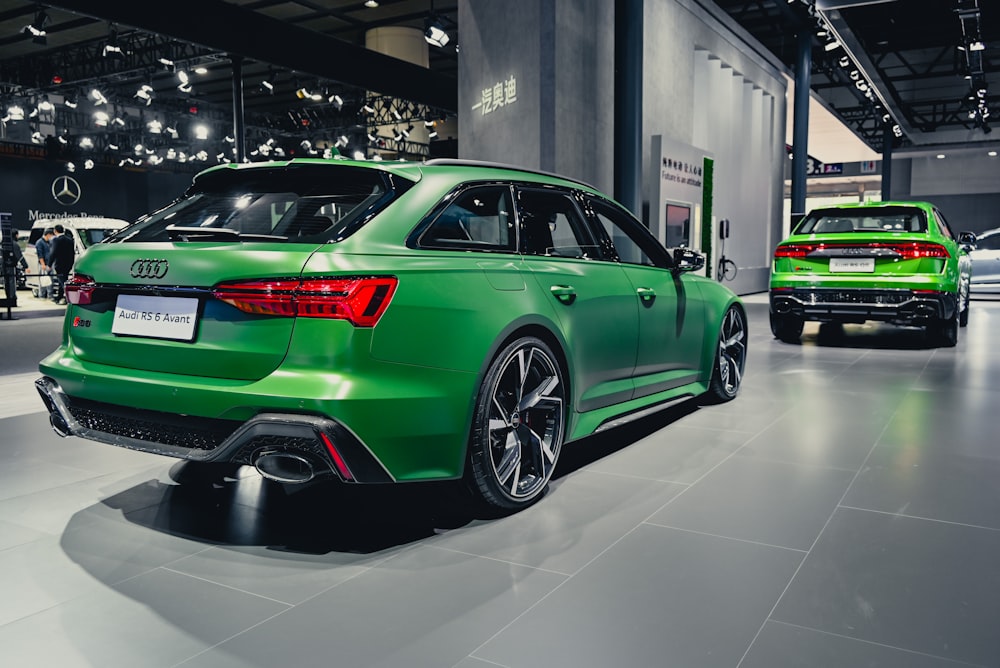 a green car is on display at a car show