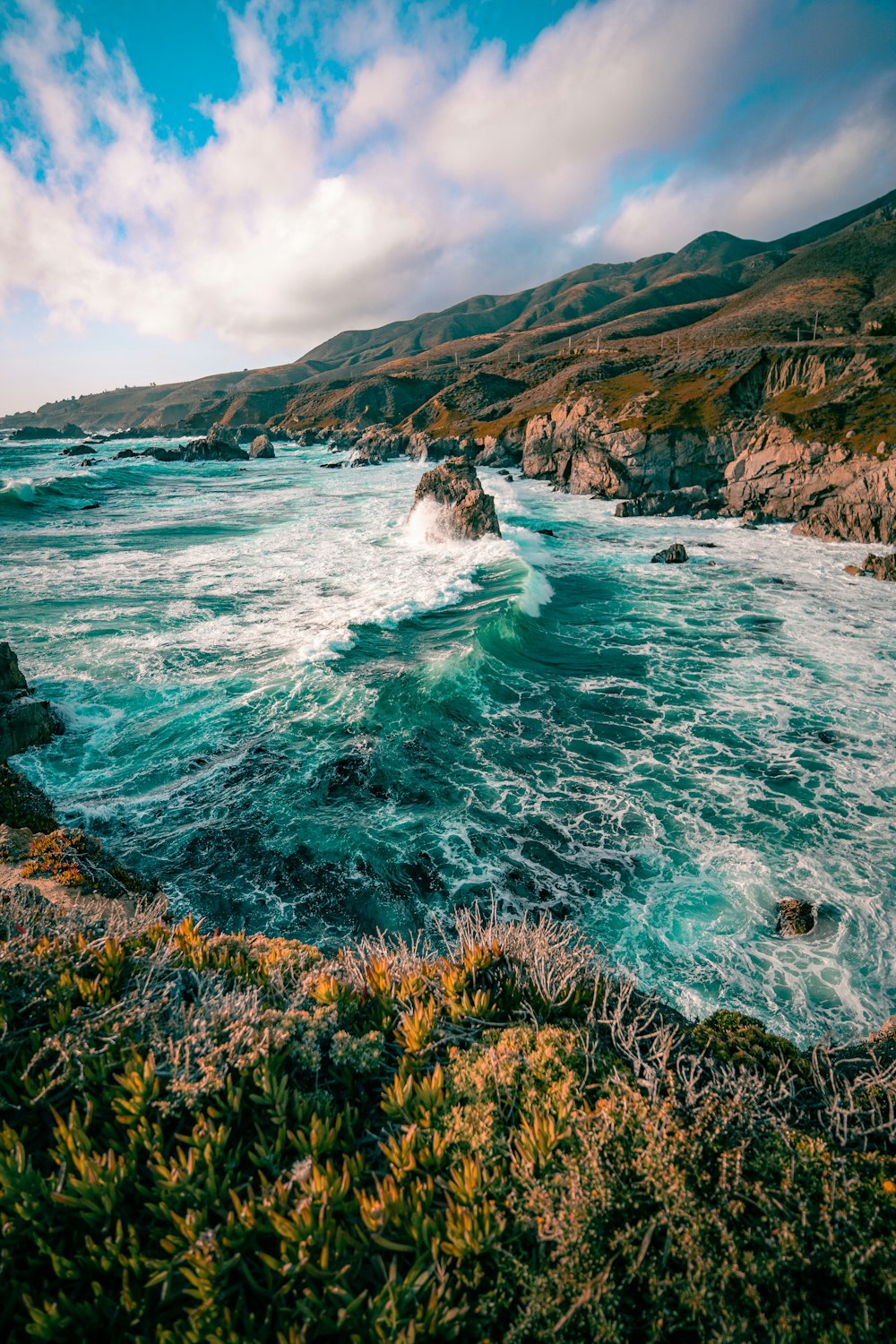 a body of water near a rocky shore