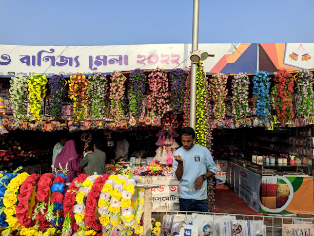 Colorful flower stalls and smiling vendors welcoming visitors during the Boundary Road Festival.