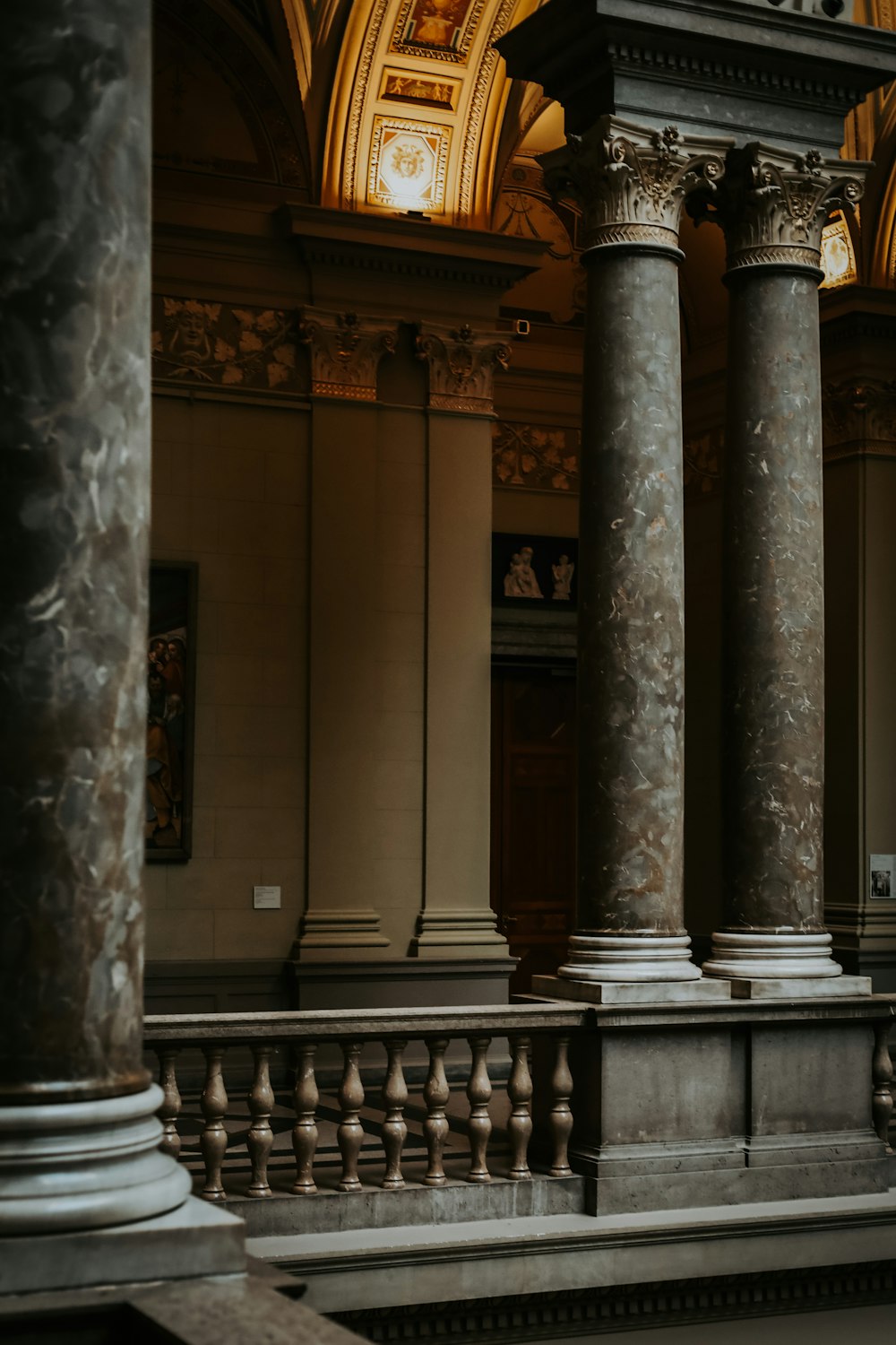 a couple of pillars in a building with a clock