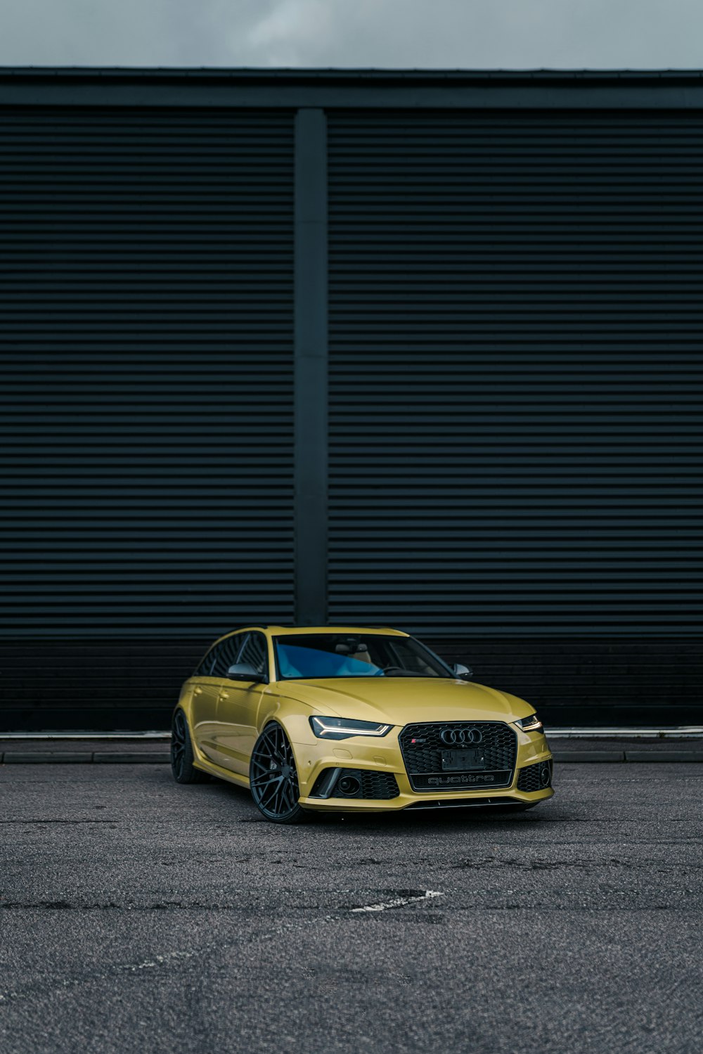 a yellow car parked in front of a building