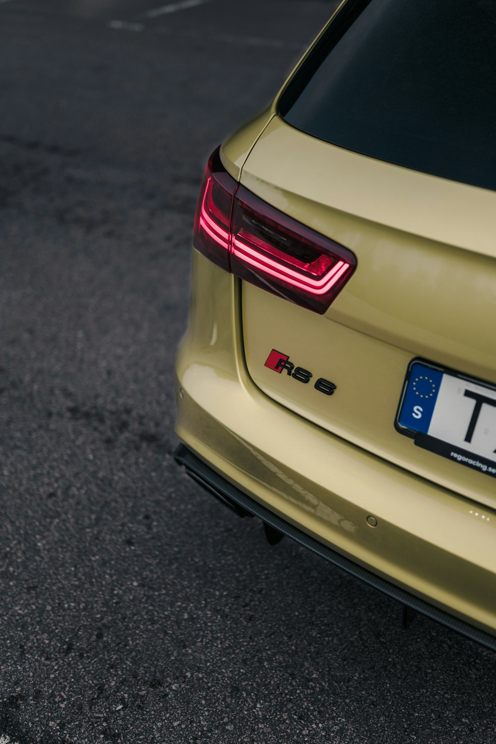 a close up of the tail light of a yellow car