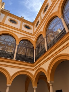 the inside of a building with arches and windows