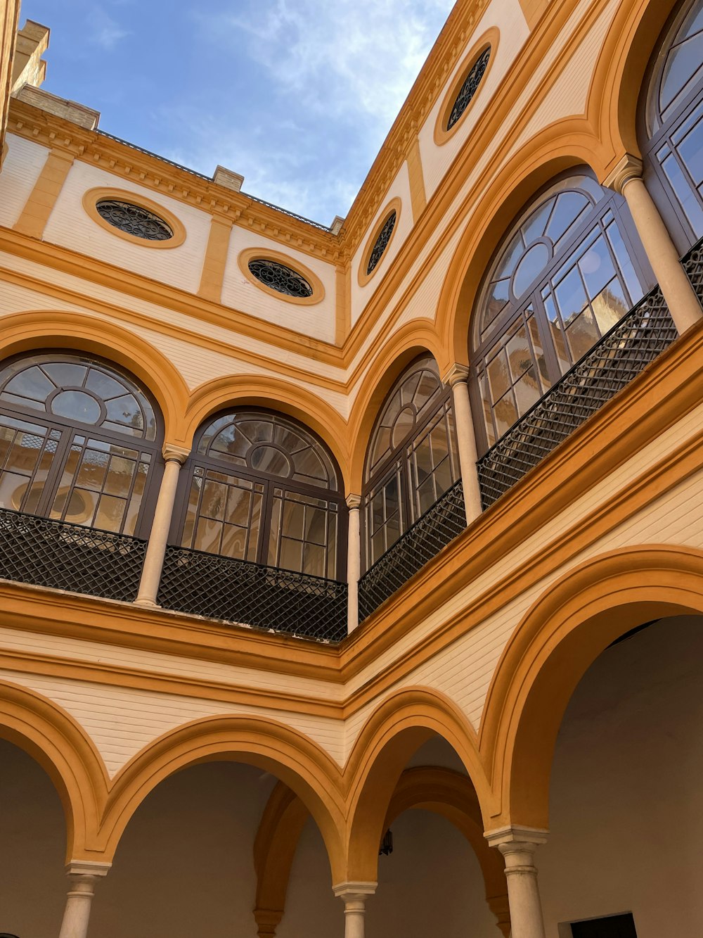 the inside of a building with arches and windows