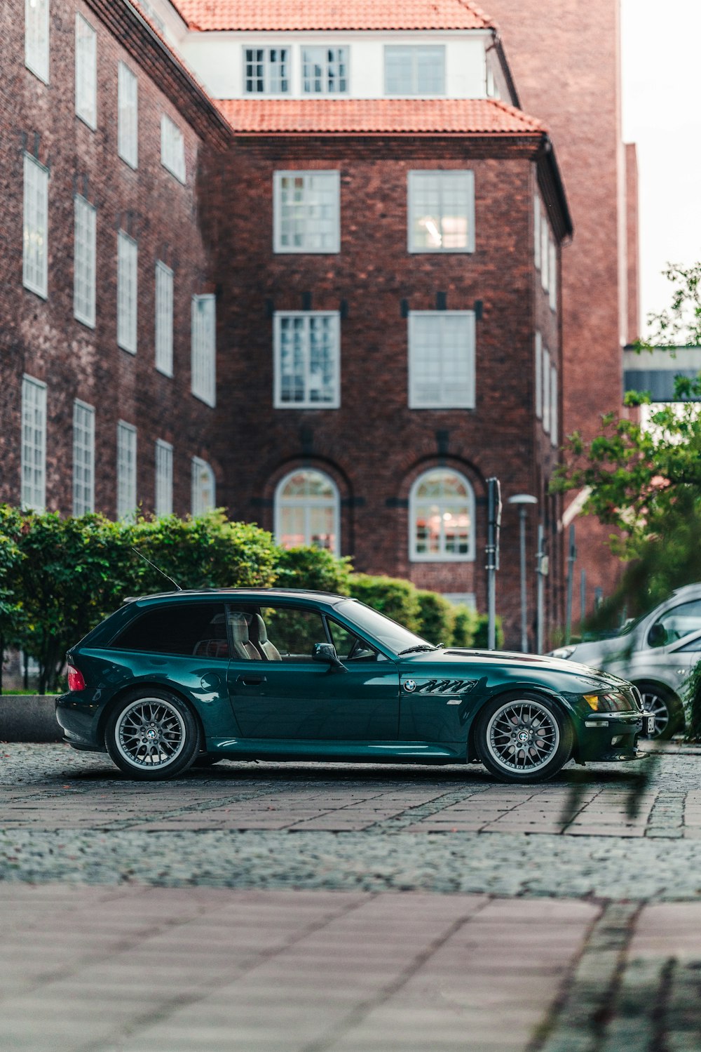 a couple of cars parked next to each other on a street