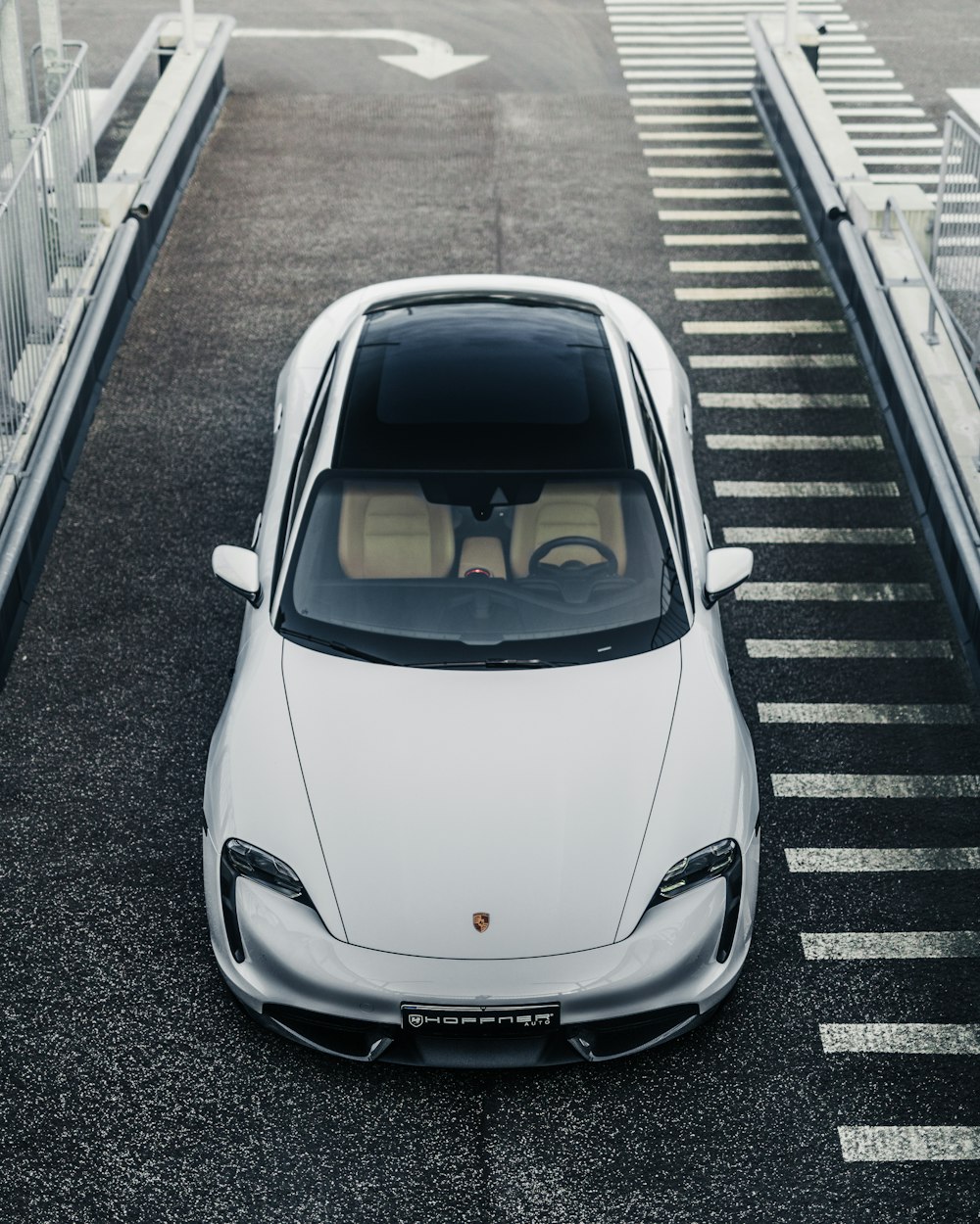 a white sports car parked in a parking lot