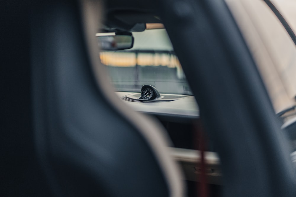 a rear view mirror of a car with a car's reflection in it