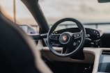 Interior shot of Porsche 911 showing luxurious leather seats and dashboard.