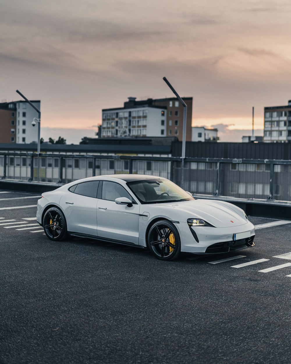 a white sports car parked in a parking lot