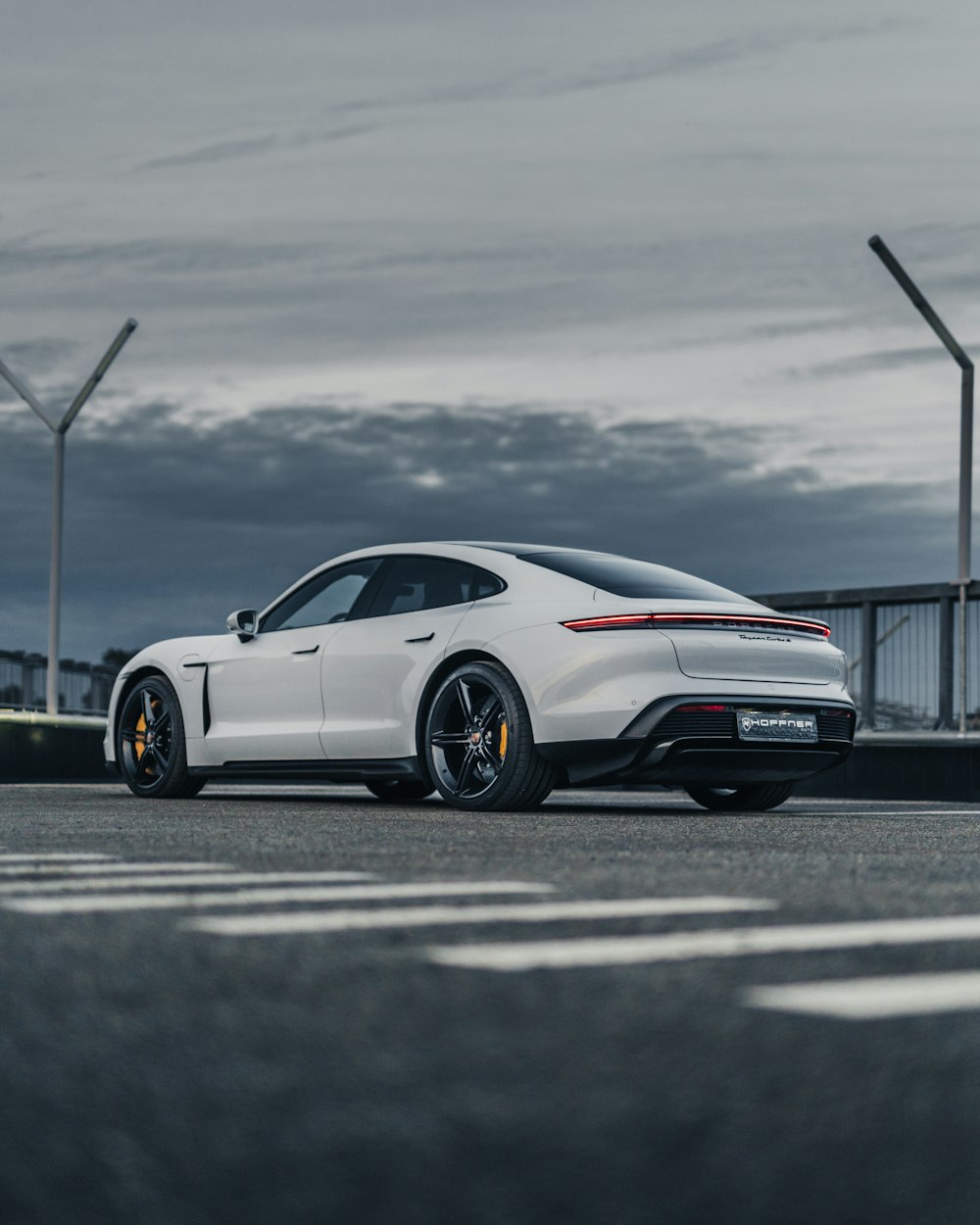 a white sports car parked in a parking lot