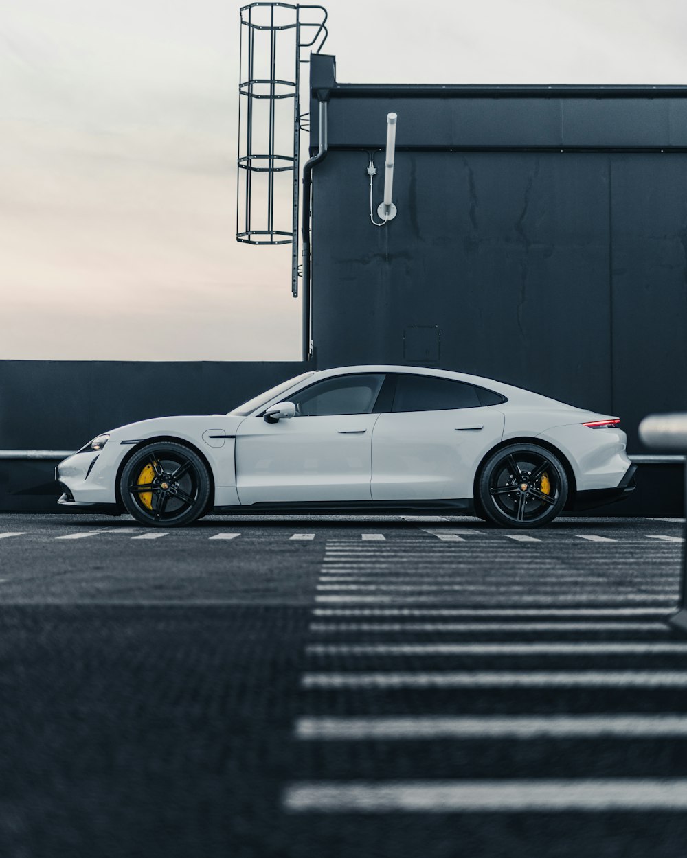 a white sports car parked in a parking lot