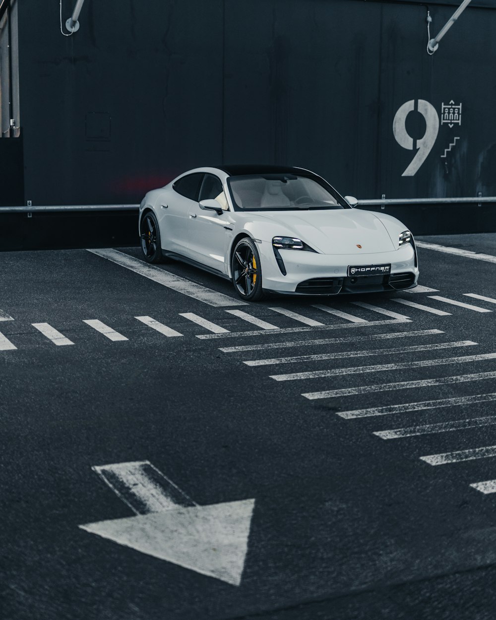 a white sports car parked in a parking lot
