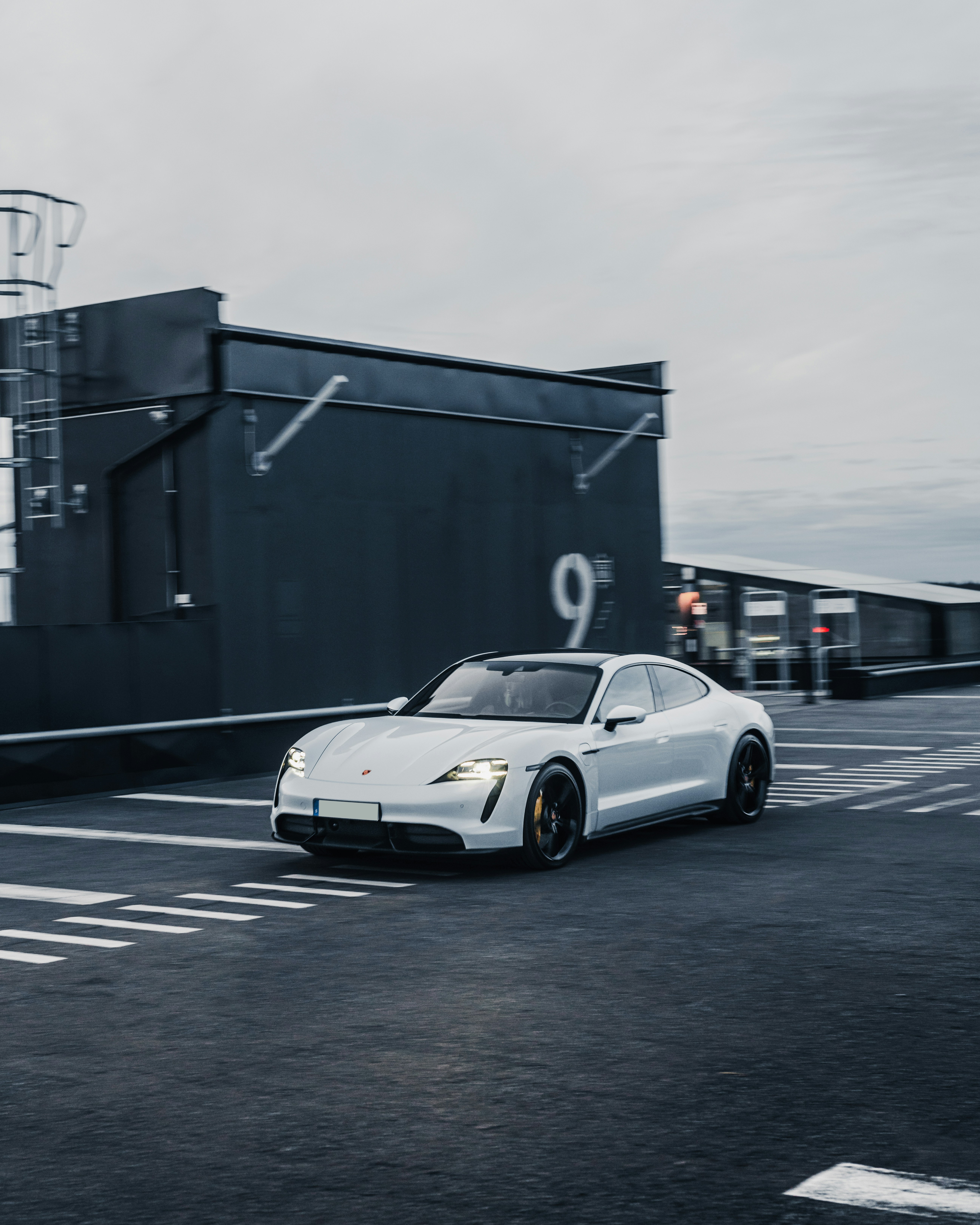 a white sports car parked in a parking lot
