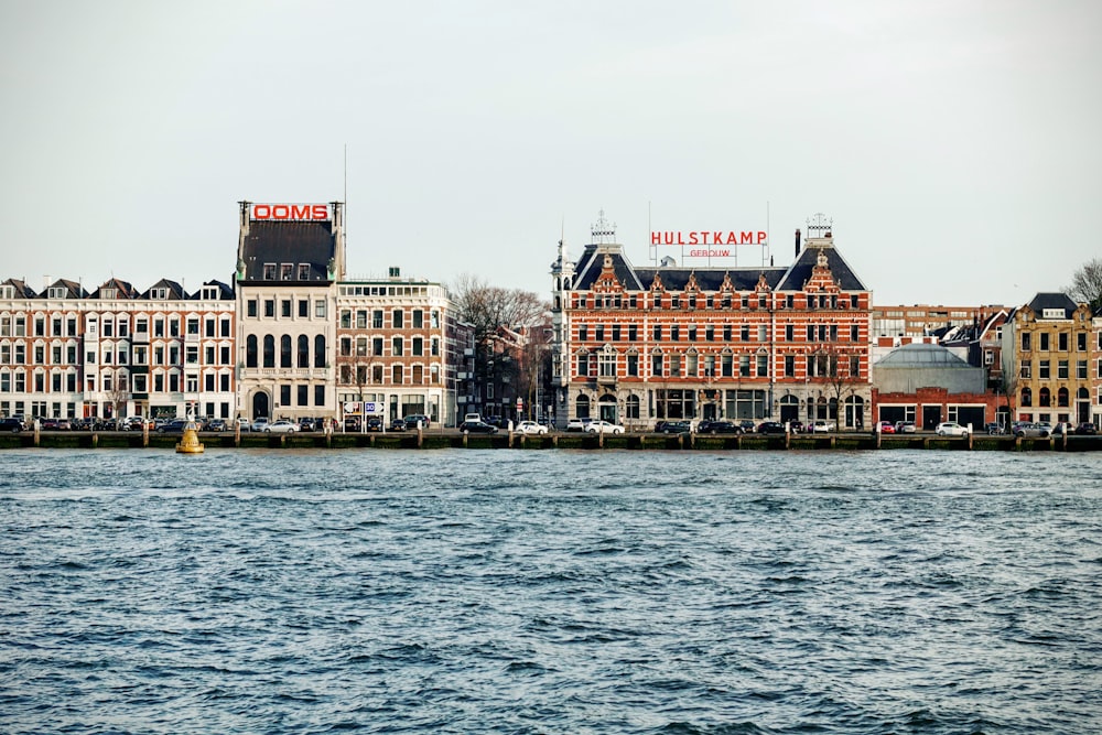 a large body of water with buildings in the background