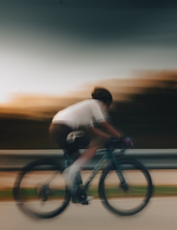 a blurry photo of a man riding a bike