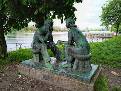 a statue of two people sitting on a bench