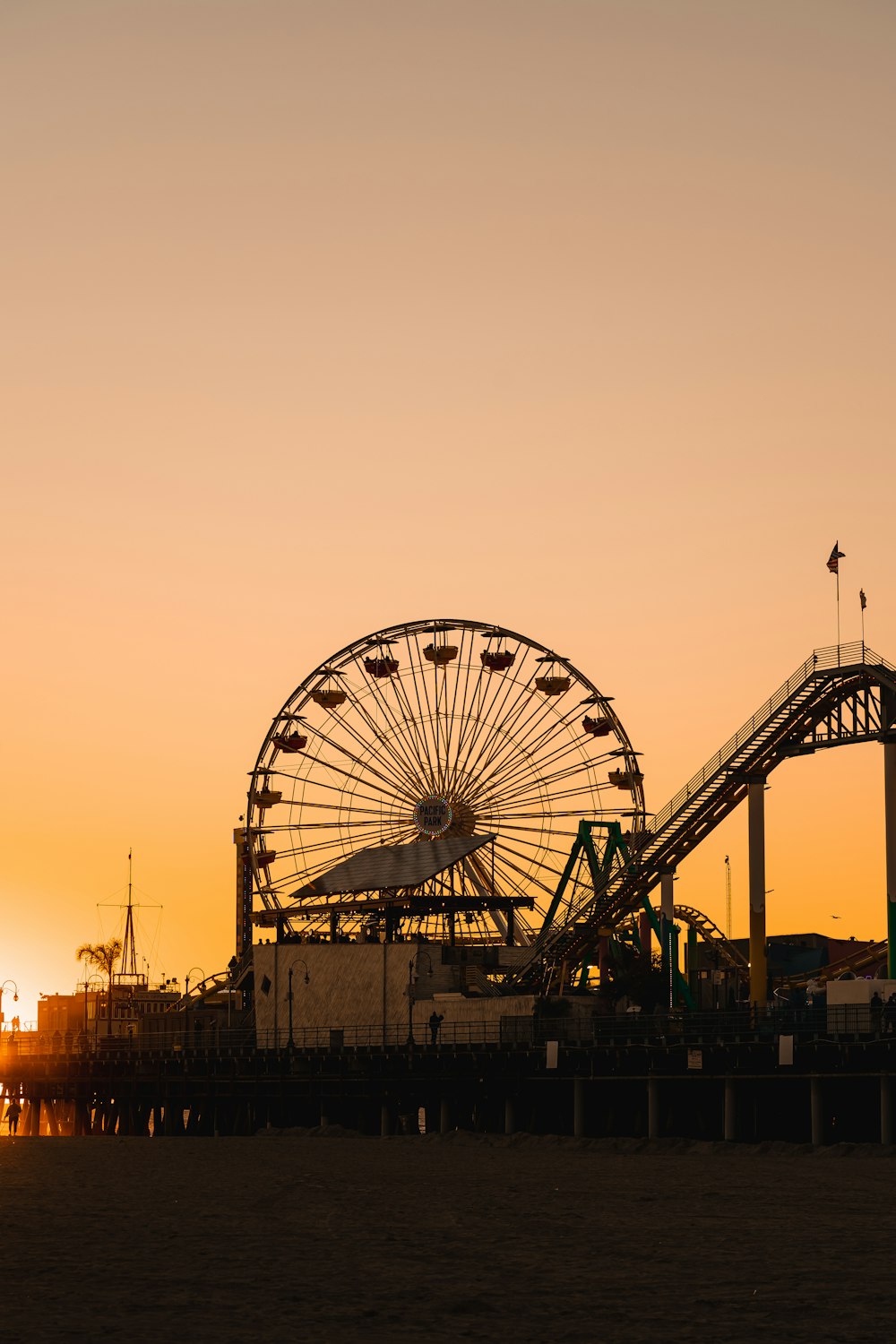 a large ferris wheel sitting next to a pier