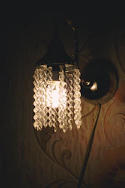 Elegant crystal hanging lamp casting a warm glow in a cozy living room