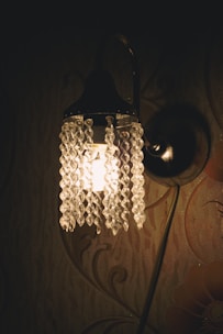 Close-up of decorative lighting fixtures casting elegant shadows on a wall.