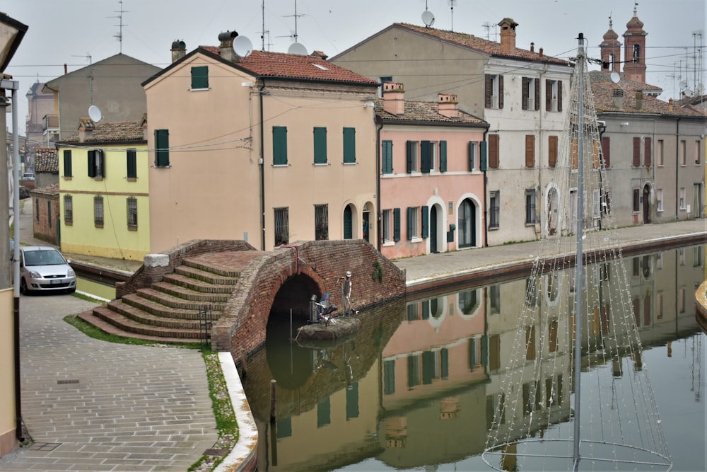 a canal running through a small town next to tall buildings