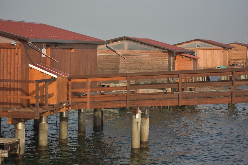 a row of wooden buildings sitting on top of a body of water