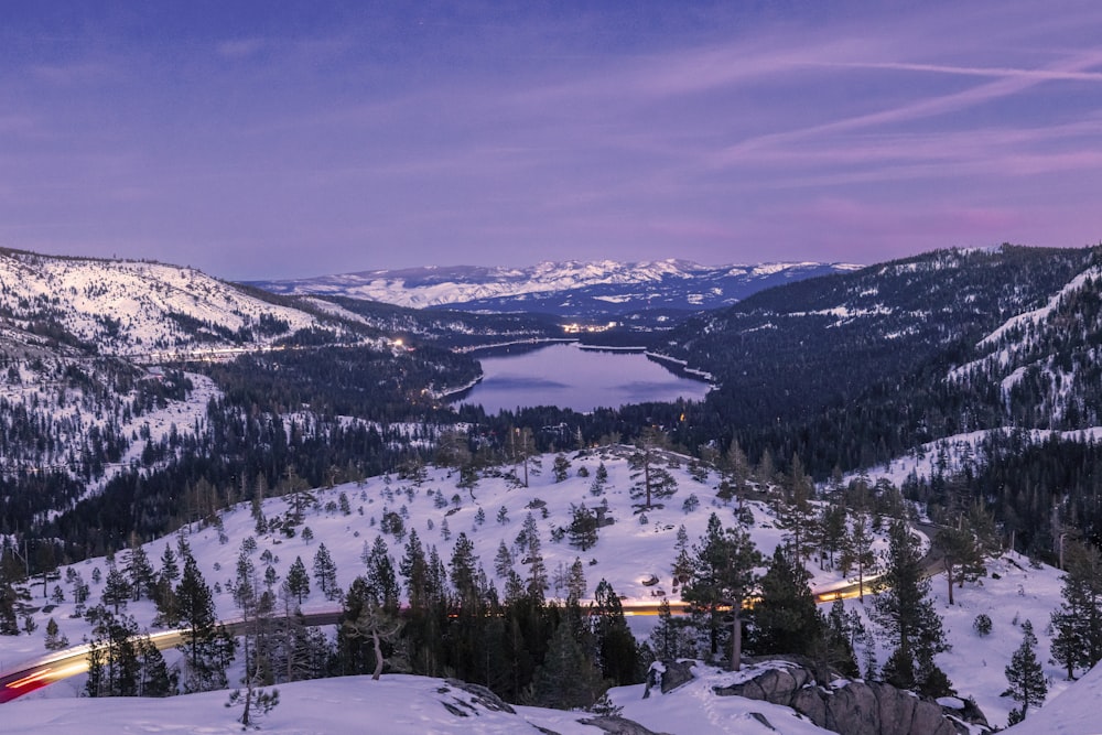 a scenic view of a mountain with a lake in the distance