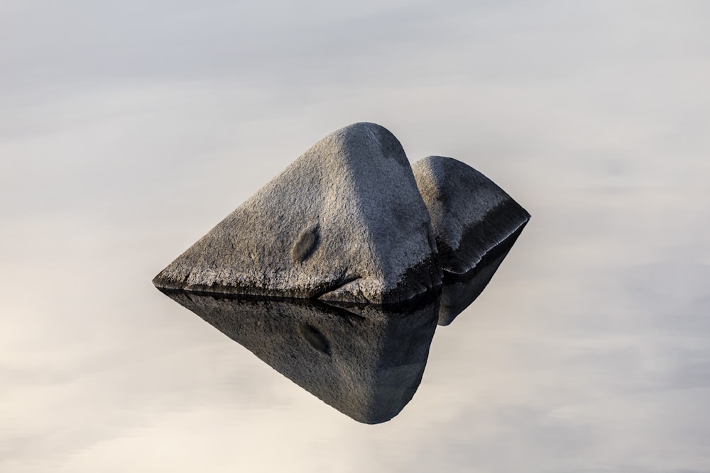 a rock in the middle of a body of water