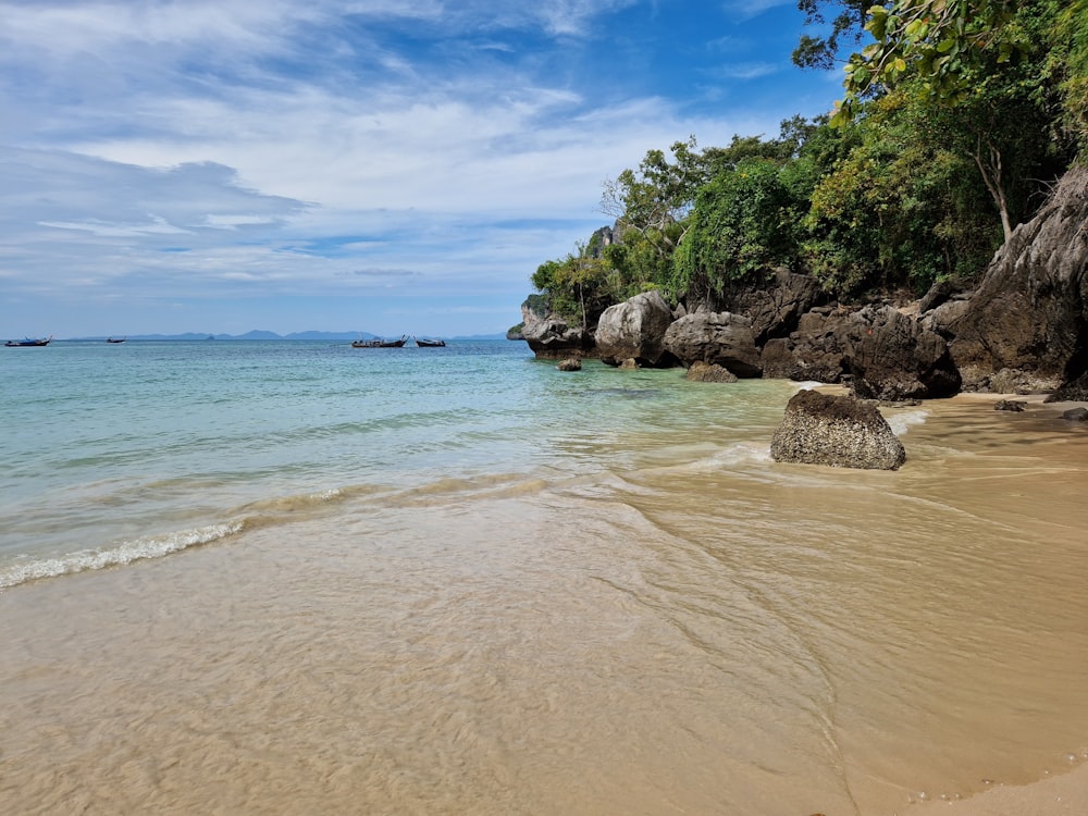 a beach that has some rocks in the water