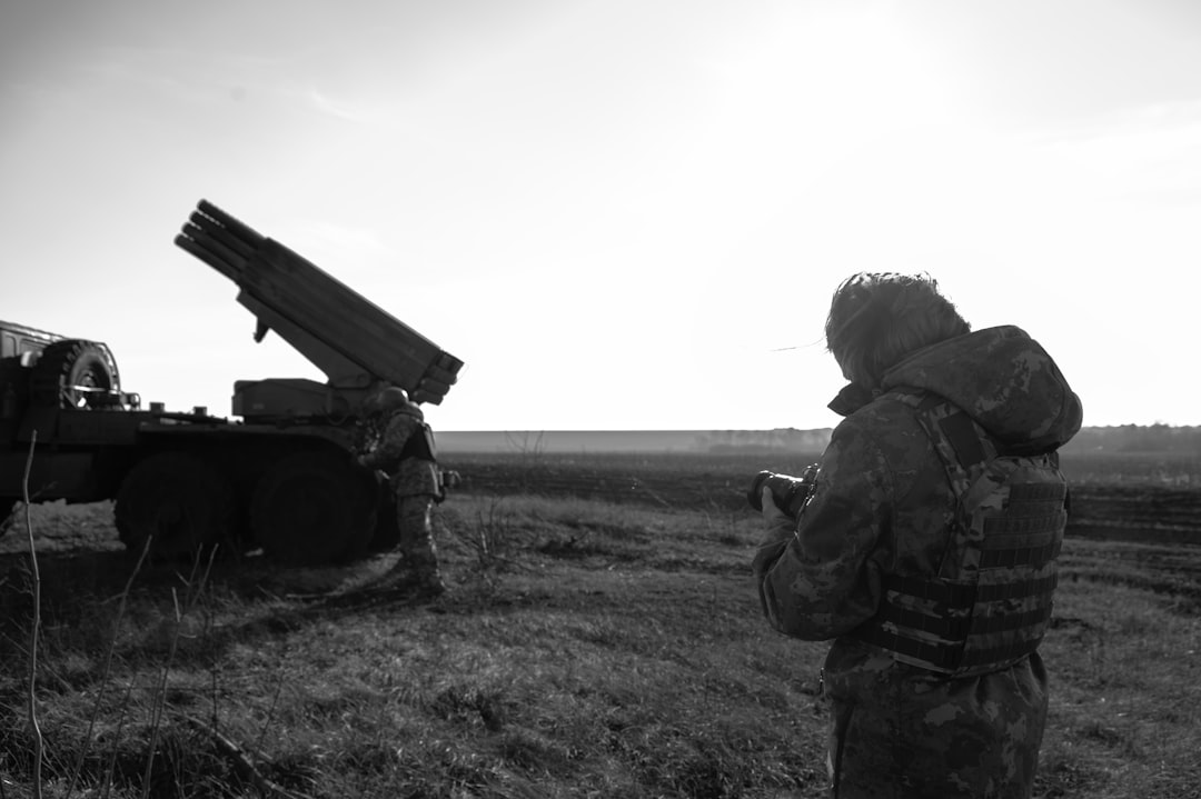 a man standing next to a truck in a field