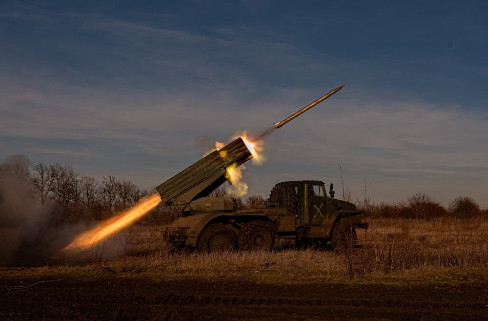a military vehicle with a missile in the air
