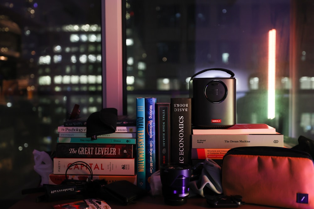 a stack of books and a camera on a table