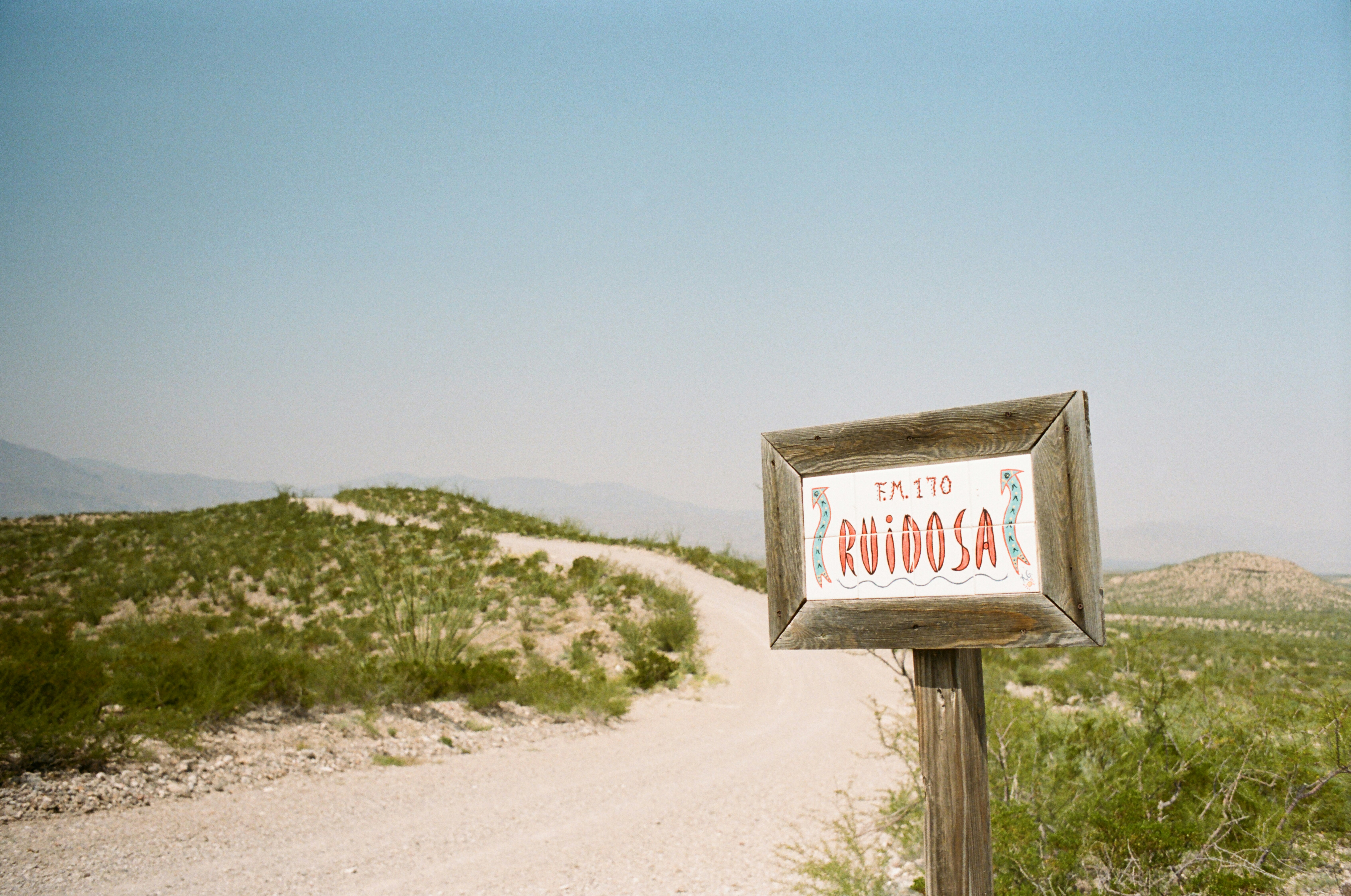 How 'Choosin' Texas' Climbed to 22 Weeks at Number One — a sign on the side of a dirt road