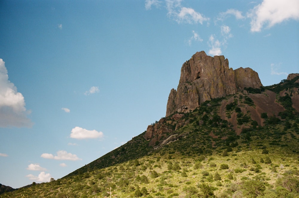 a very tall mountain with a sky in the background